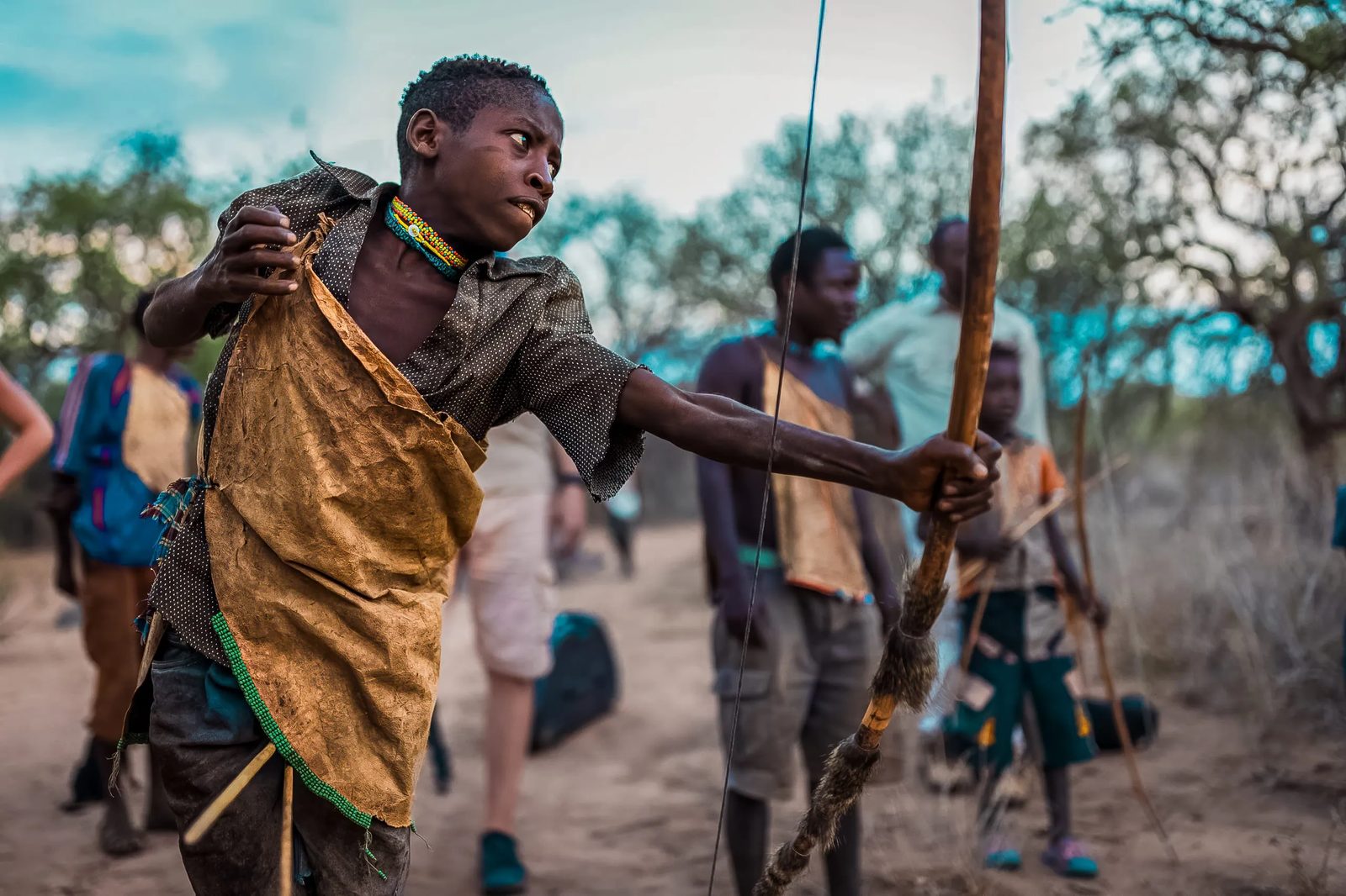 A Hadza archer draws a bow on the Tanzania Survival Safari.
